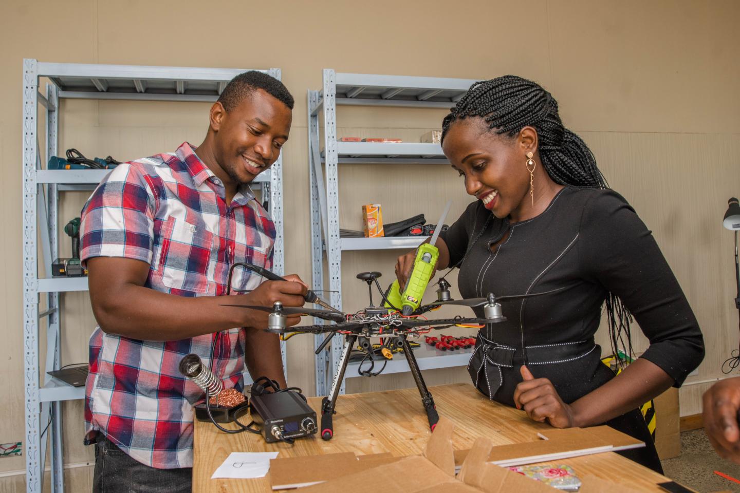 Two students at the Africa Drone and Data Academy in Malawi soldering drone components. The ADDA is a global leader in drone training developed by UNICEF and Virginia Tech.